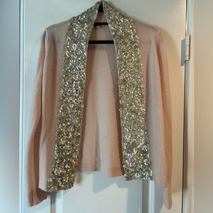 Light pink cardigan sweater.